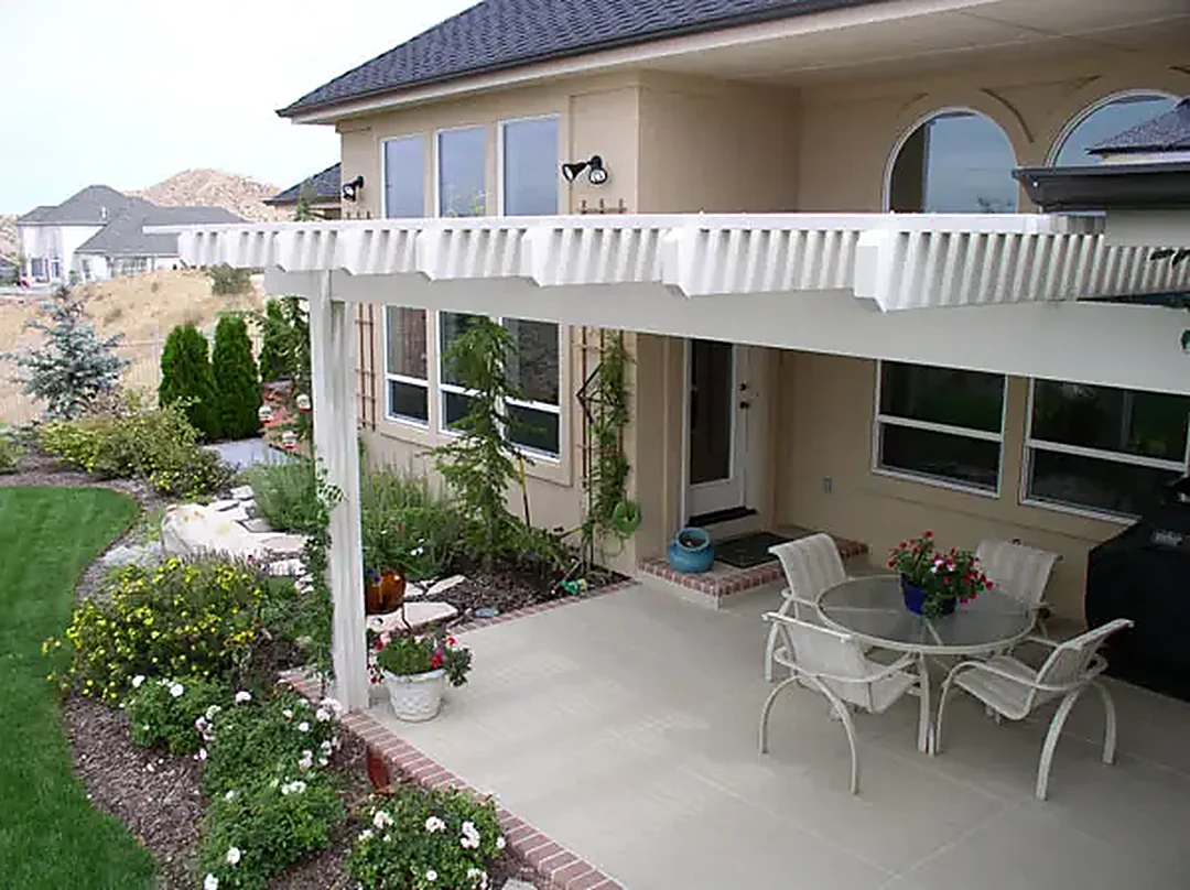 A finished residential patio in random flagstone, laid up to the house and edged against the lawn.